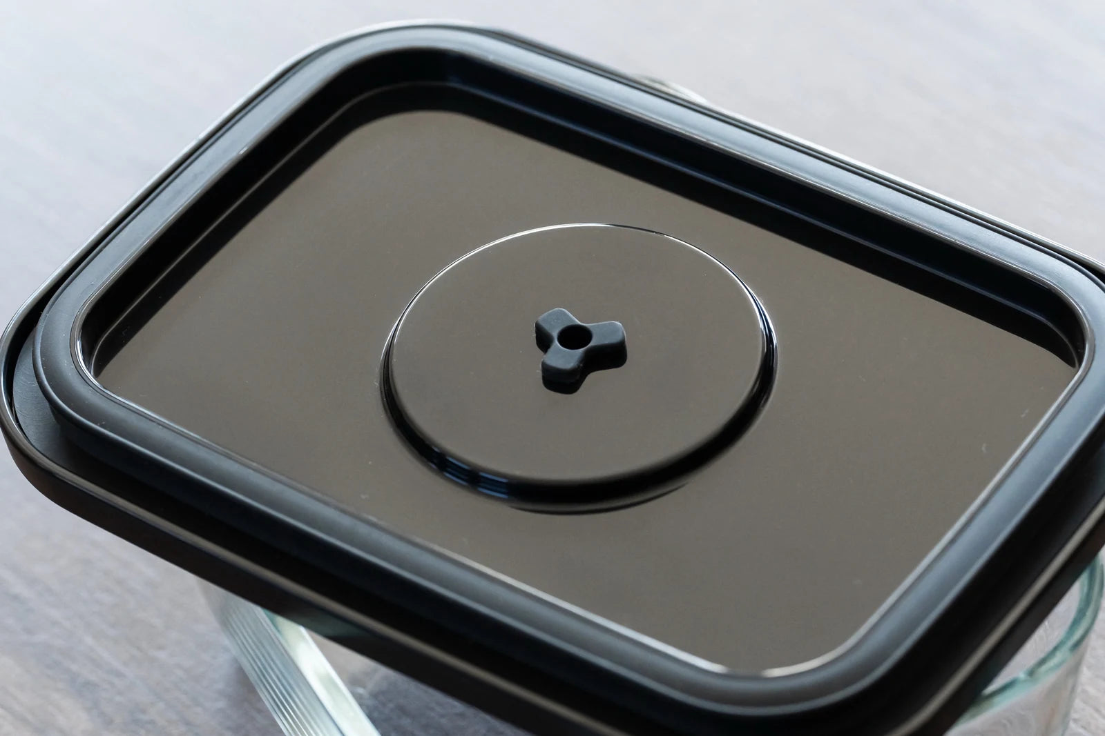 実物の黒い蓋裏面。中央のバルブと外周のパッキンのクローズアップ